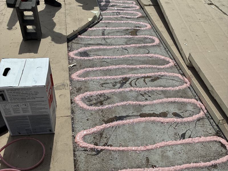 Foam adhesive applied for flat roof insulation